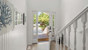 A staircase leading to a deck with a view of a tree-lined street. - 723 Seahorse Road (Fripp Island)