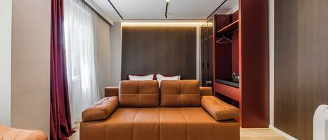 A modern room with a sofa, a wardrobe, and a mirror.
