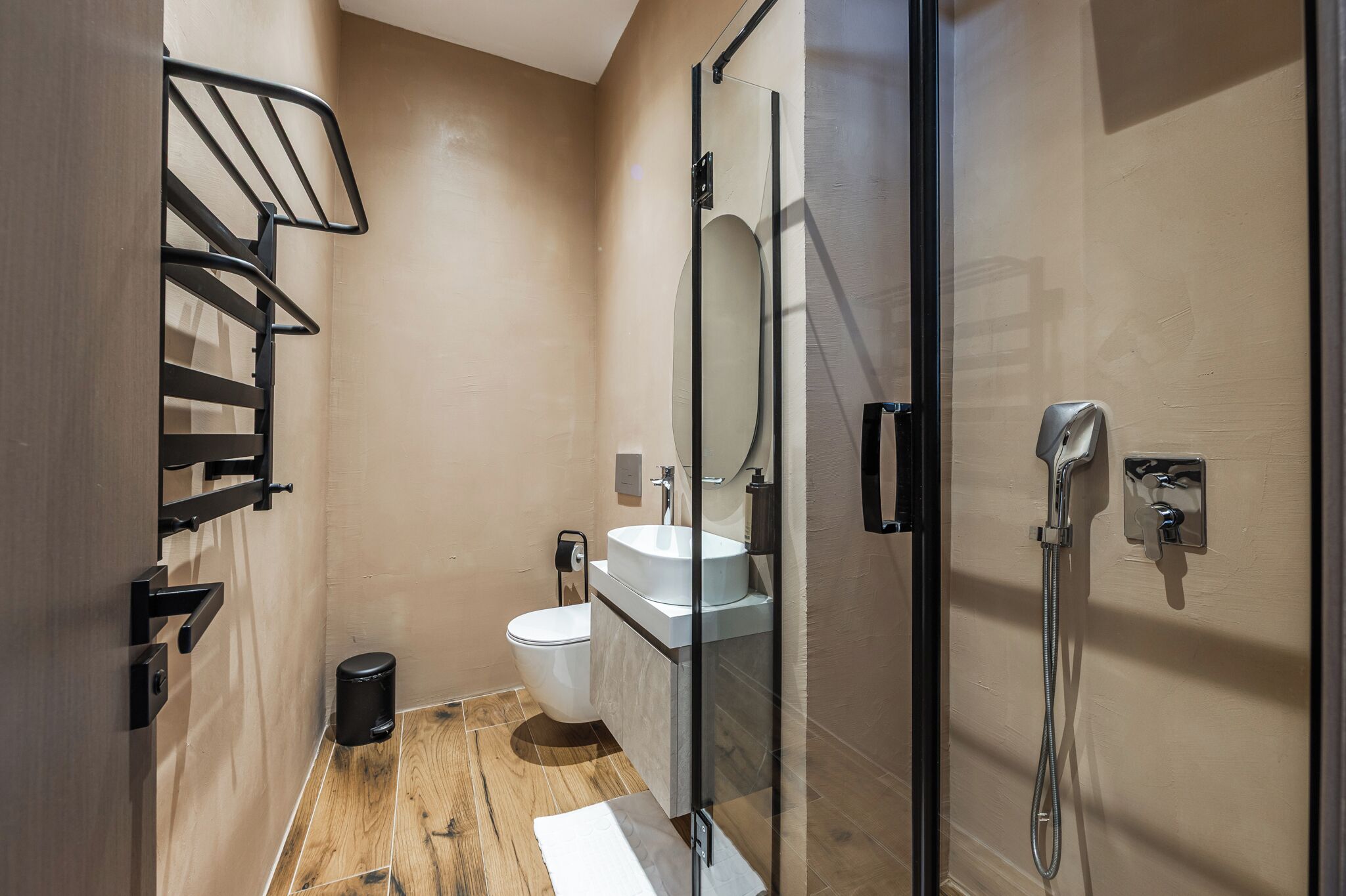 A modern bathroom with a toilet, sink, and shower.