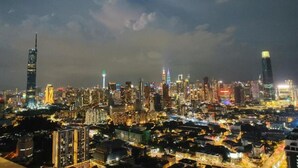 A cityscape at night with illuminated skyscrapers and dense urban development. - Trion Hotel Suites By Havenza (Kuala Lumpur)