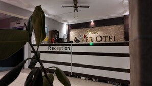 A reception desk with a sign reading 'Reception' and a 'Grand Hotel' sign above it. - GRAND ALVER OTEL (Edremit)