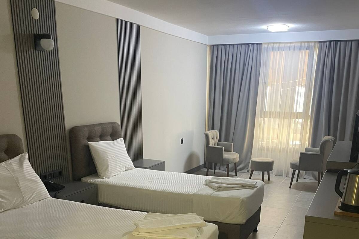 Luxury Triple Room, Beach View | In-room safe, laptop workspace, blackout drapes, soundproofing