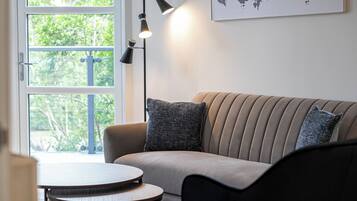 Standard Apartment (2 Bedrooms) | Living area | 32-inch flat-screen TV with digital channels