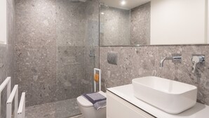 A modern bathroom with a shower, toilet, and sink. - LIV Athinum 1 - Luxury Apartment 2A (Athens)