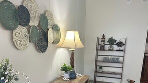 A wooden reception desk with a lamp, a welcome sign, and decorative plates on the wall. - WATERFRONT with private dock ,boat ramp, paddle boats and Kayaks!! (Many)