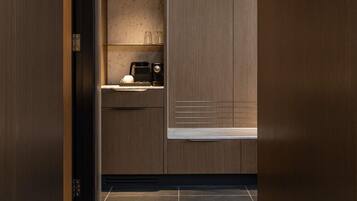 A modern kitchen with wooden cabinets, a countertop, and a window.