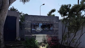 A building with a sign that reads "Res. San Miguel" and a street lamp nearby. - Suite in San Miguel Steps from Monagas Plaza (Monagas)