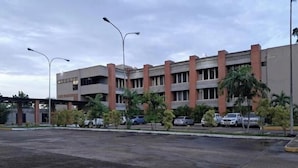 A multi-story building with a parking lot in front. - Suite in San Miguel Steps from Monagas Plaza (Monagas)
