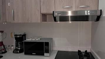 Fridge, microwave, cookware/dishes/utensils