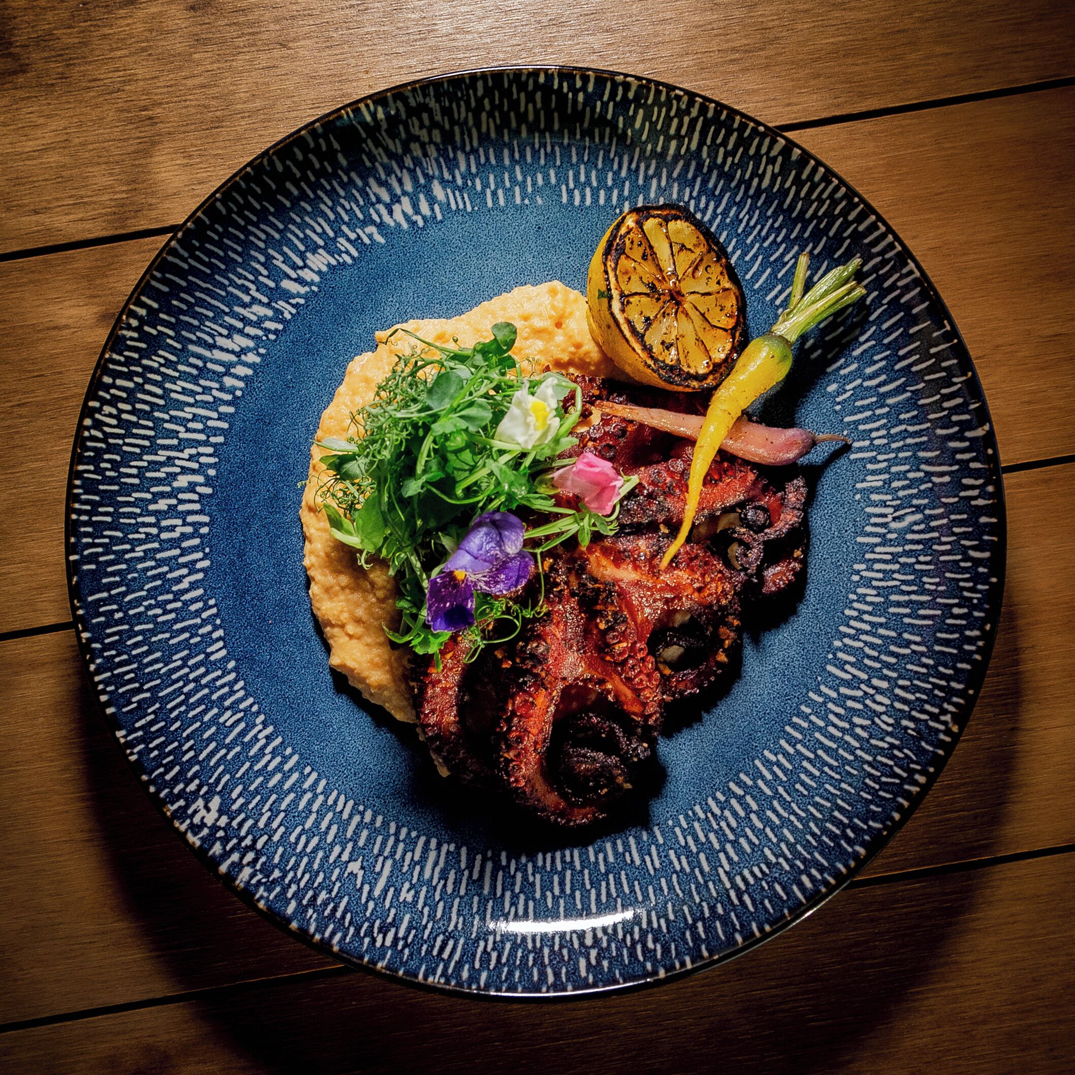 A plate of food with a blue patterned rim.