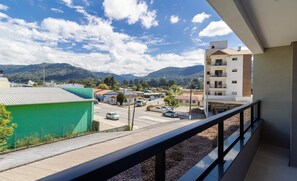 A balcony with a view of a town, buildings, and mountains. - Your Perfect Stay in Urubici Starts Here! CZZ (Urubici)