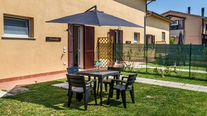 An outdoor patio with a table and chairs, a large umbrella, and a sign reading 'Lavanda.'