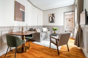 Deluxe Apartment, Courtyard View | Living area | 80-cm Smart TV with digital channels