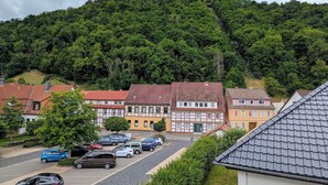 A residential area with houses, a parking lot, and a forested hill in the background. - A vacation with a view, a pleasant break in the heart of the city Dogs welcome (Bad Lauterberg)