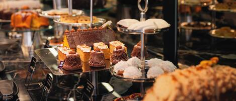A buffet with various desserts and pastries on tiered stands.