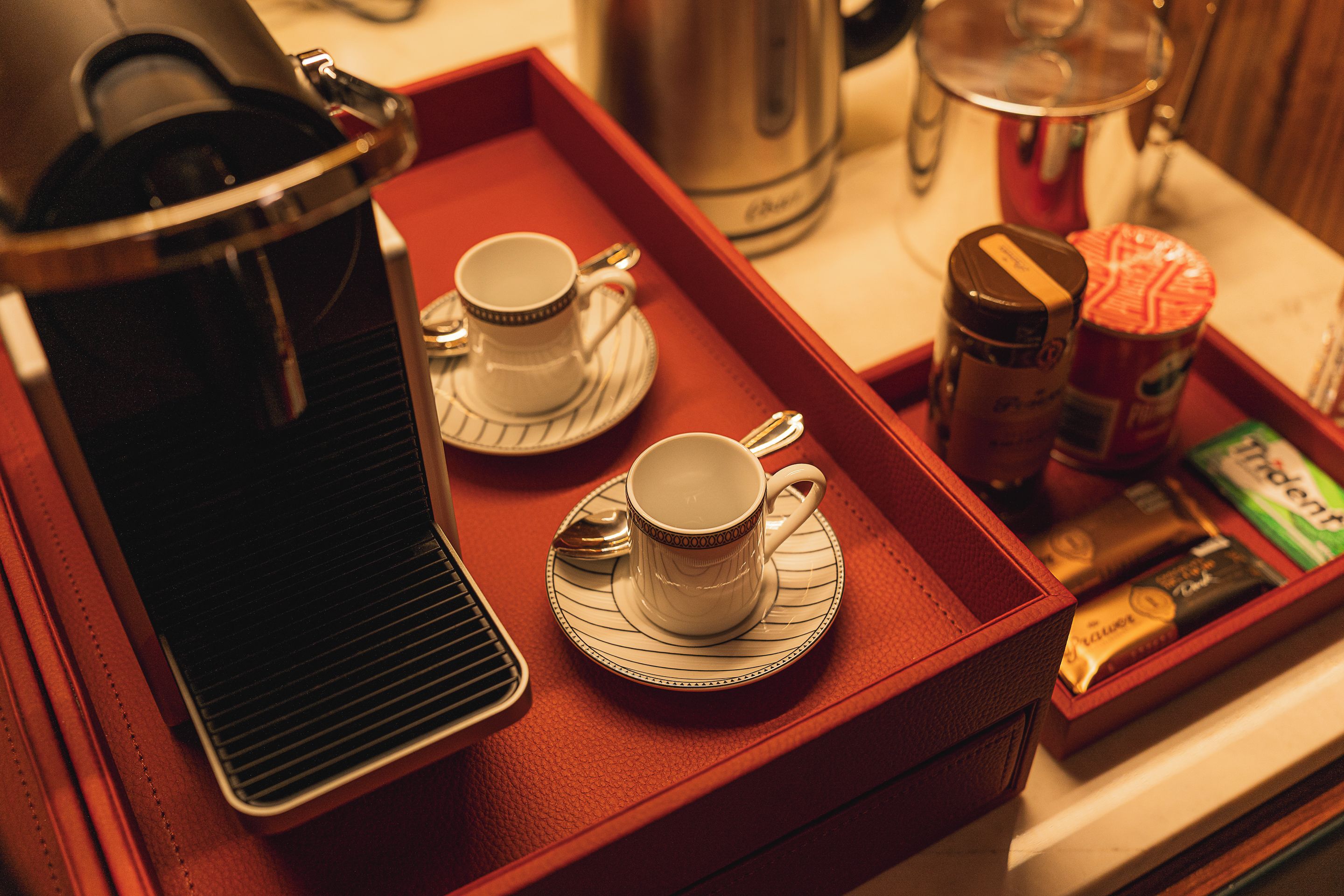 A tray with two cups and a coffee pot, suggesting a coffee service setup.
