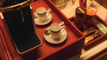 A tray with two cups and a coffee pot, suggesting a coffee service setup.