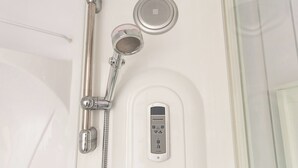 A modern shower with a handheld showerhead, a fixed showerhead, and a control panel. - Victoria Road Retreat - Charming 2 Bedroom House (Barnsley)