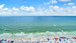 A beach with clear skies and calm waters. - Majestic Beach Towers 1-2003 (Panama City Beach)