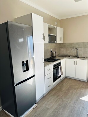 Private kitchen - 1 bedroom apartment with stunning mountainous and sunset views. (Windhoek)