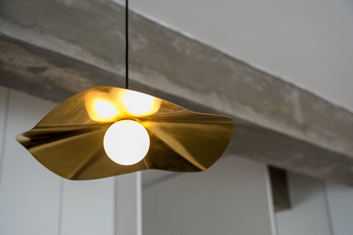 A pendant light with a unique, metallic design.