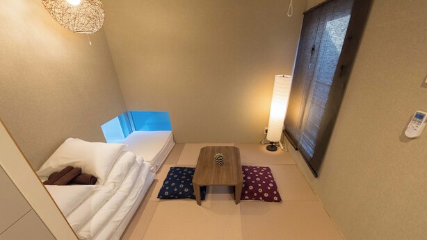 A compact hotel room with a bed, a small table, and a bedside lamp. - Fare Metallo Hote 1-Tatami bedroom 201, Nakano City, Near Shinjyuku (Nakano City)