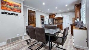 A modern kitchen with white cabinets, a wooden countertop, and a built-in oven. - Apollo Creed’s Powder Mountain Ski - Golf Retreat (Eden)