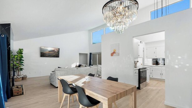 A modern kitchen with white cabinets and a built-in oven.