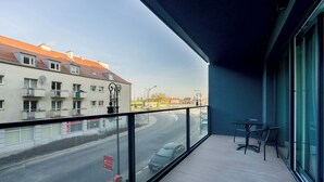 A balcony with a view of a street and buildings.