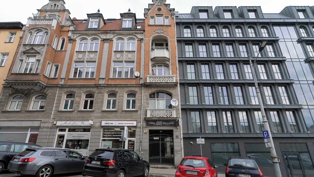 A building with a classic architectural style, featuring ornate facades and large windows.
