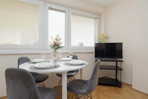 A window above the table brightens the space, perfect for shared meals.