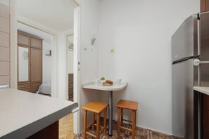 A small breakfast nook by the entrance is a functional spot for quick meals.