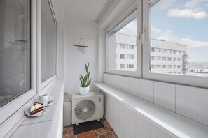 The loggia with a window and plant is perfect for morning tea or evening relaxation.