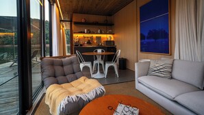 Una sala moderna con un sofá, una mesa de centro y un comedor con sillas y una mesa.