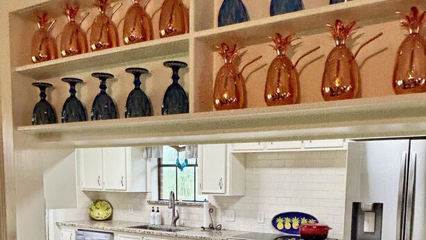 A kitchen with white cabinets, a stainless steel refrigerator, and a granite countertop. - Beautiful country home escape for a Country Christmas in Bellville, TX (Bellville)