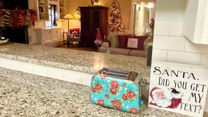 A kitchen with a granite countertop, a Christmas tree, and a sign reading "Santa, did you get my text?" - Beautiful country home escape for a Country Christmas in Bellville, TX (Bellville)