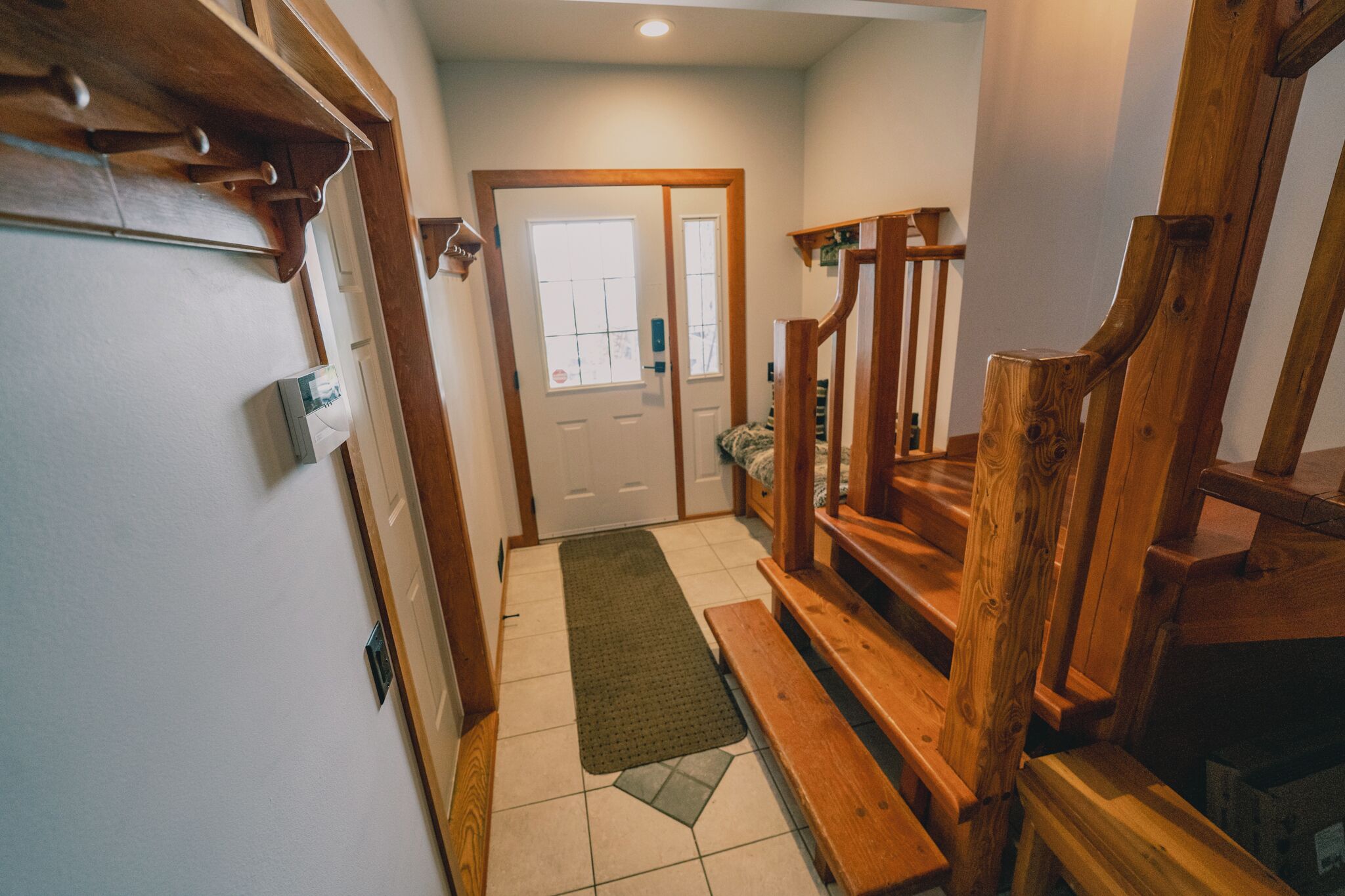 A wooden staircase leading to a door with a window.