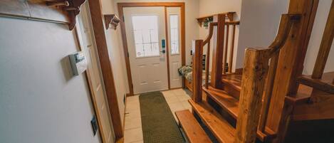 A wooden staircase leading to a door with a window.