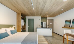 A modern hotel room with a bed, a small kitchenette, a dining area, and a bathroom. - Nwts - Studios in Building With Sea View (Maceió)