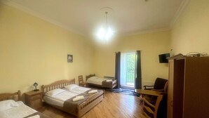 A hotel room with two beds, a desk, a chair, a wardrobe, and a window with curtains. - Noor Dilijan (Dilijan)