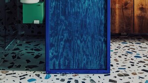 A bathroom with a blue door, a green sink, and a wooden cabinet. - Apartament przy MCK (Katowice)