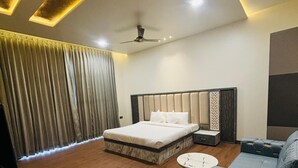 A modern bedroom with a large bed, a sofa, and a coffee table.