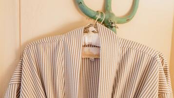 A striped garment hanging on a wooden wall.