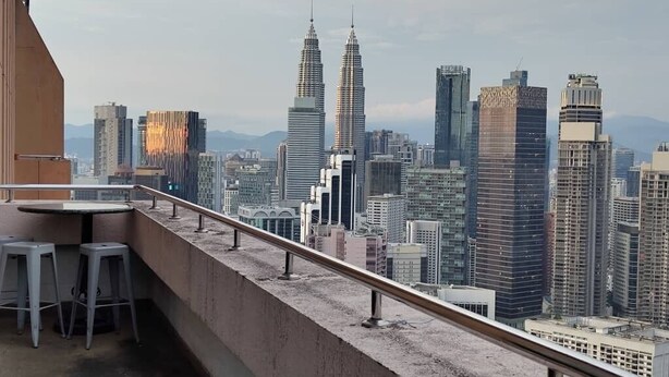 A high-rise building with a view of a cityscape, including a prominent twin tower structure. - 4-bedroom apartment in marvelous City with AC, fitness room (City)
