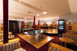 A room with ping pong tables, pool tables, and a dart machine. - Aquamarina Hotel Visegrád (Visegrád)