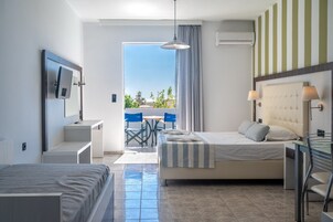 Une chambre d’hôtel avec un lit, un bureau, une chaise et une vue sur l’extérieur.