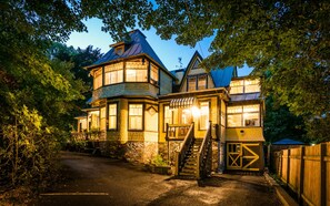 A large, multi-story building with a prominent tower and a covered porch area. - Victorian inn dating from 1864 with spa - sleeps 18 (WATERLOO)