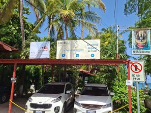 A hotel entrance with signs for 'Hotel Brasilito' and 'Mar y Tierra Steak House & Sport Bar.' - Hotel Brasilito (Cabo Velas)