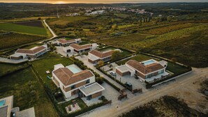 An aerial view of a residential area with modern houses, a swimming pool, and a vineyard. - Luxury villa with pool and panoramic views - the perfect vacation in the heart of Istria (Brtonigla)