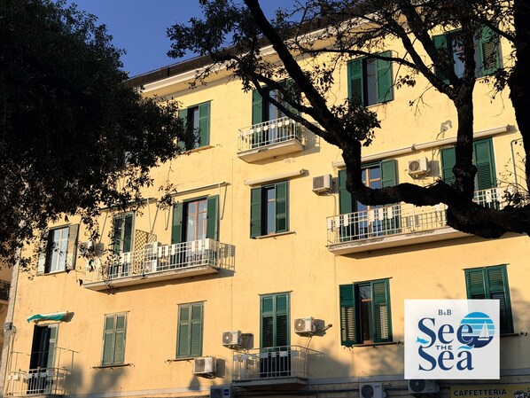 A building with multiple balconies, air conditioning units, and a sign for 'See the Sea' hotel. - See The Sea B&B (Salerno)
